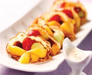 Crepes and summer fruit salad with sour cream and maple sirup